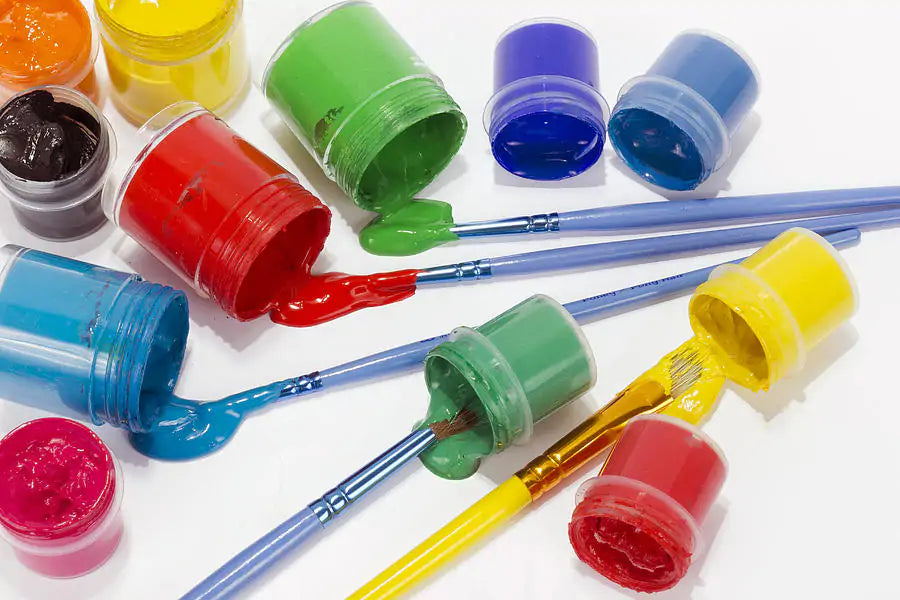 Vibrant hobby acrylic paint pots and detail paintbrushes arranged neatly inside a specialized craft drawer storage organizer tray